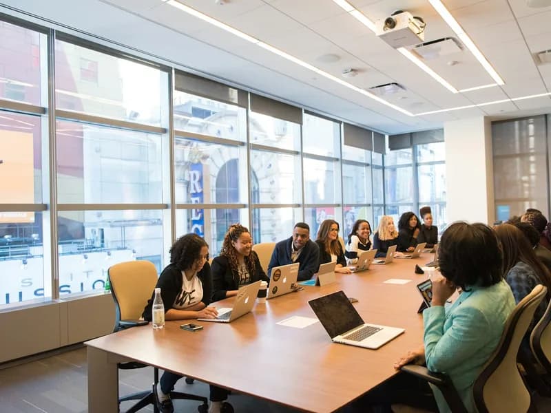 Software engineers and business consultants reviewing digital architecture and operational workflows at a table