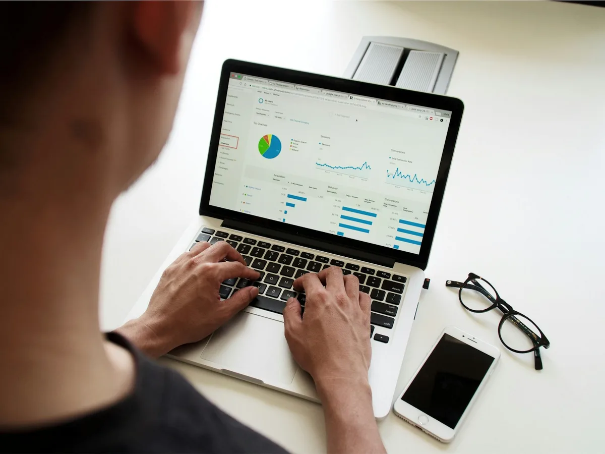 Analyst reviewing search performance and website conversion data on a laptop