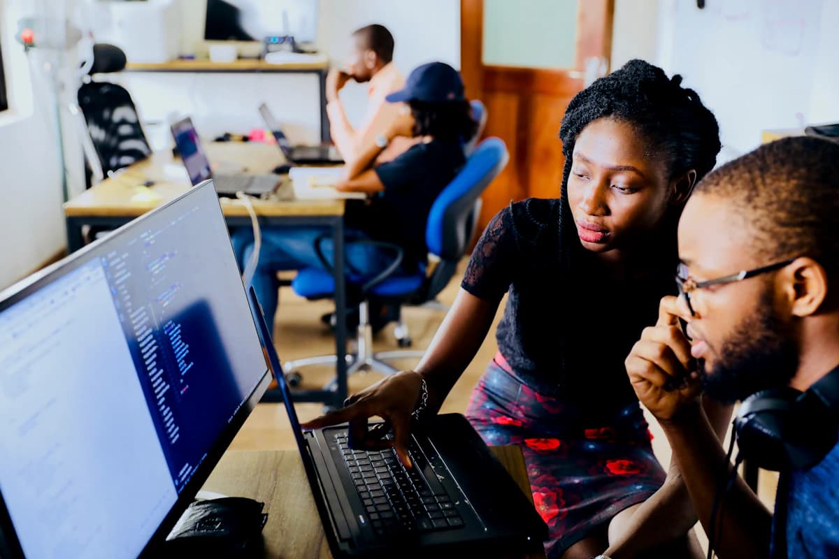 Founders and software engineers reviewing wireframes and product architecture on laptops
